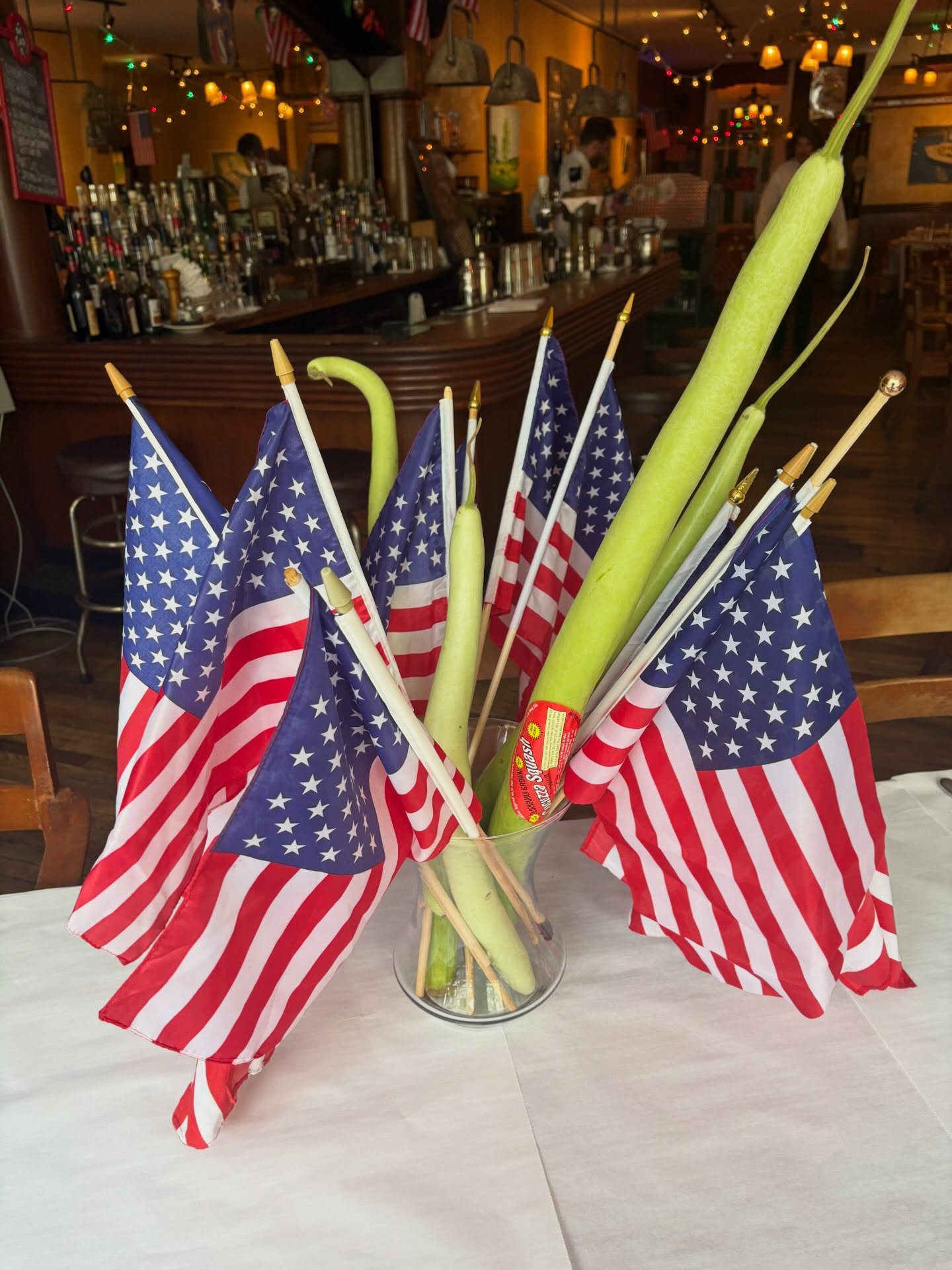 Warm bar interior with string lights and flags